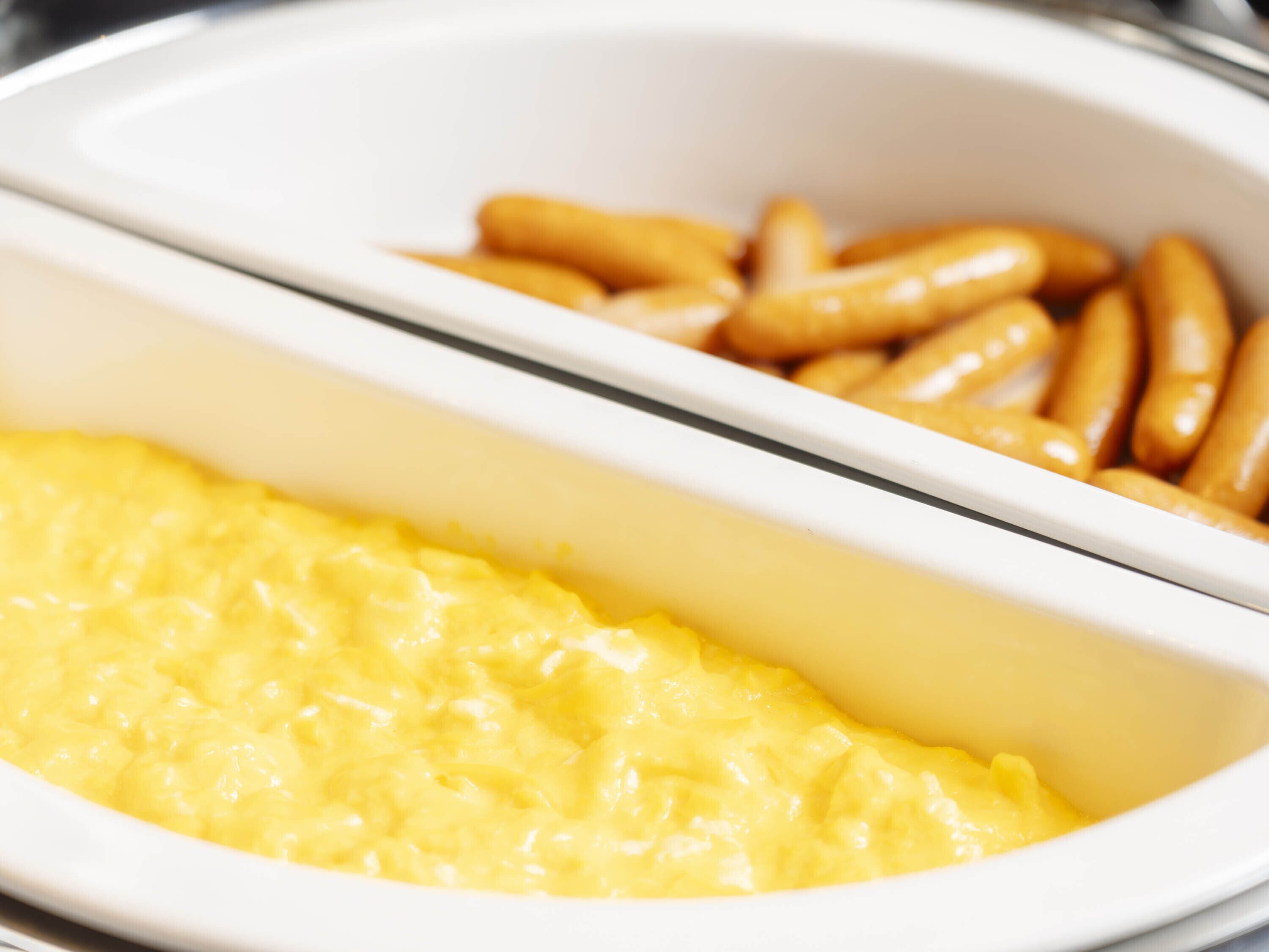 A buffet with scrambled eggs and French fries.