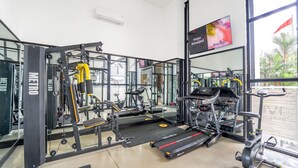 A gym with various exercise equipment, including treadmills and weight machines. - Grand Kangen Hotel Urip Sumoharjo Yogyakarta (Yogyakarta)