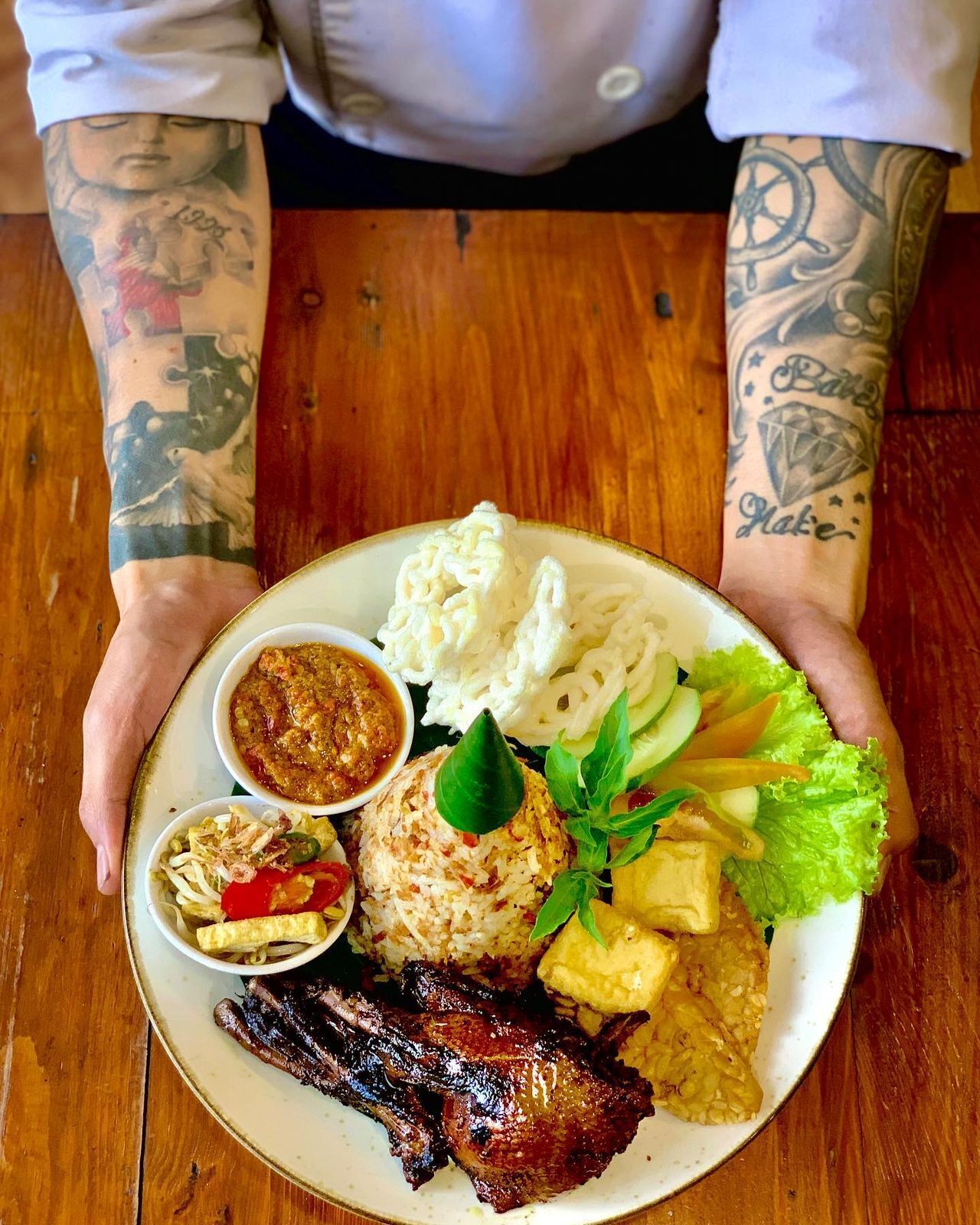 A plate of food with various dishes including rice, vegetables, and meat.