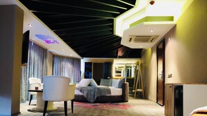 A modern hotel room with a bed, a chair, a desk, and a large window. - Velena Hotel (Sile)