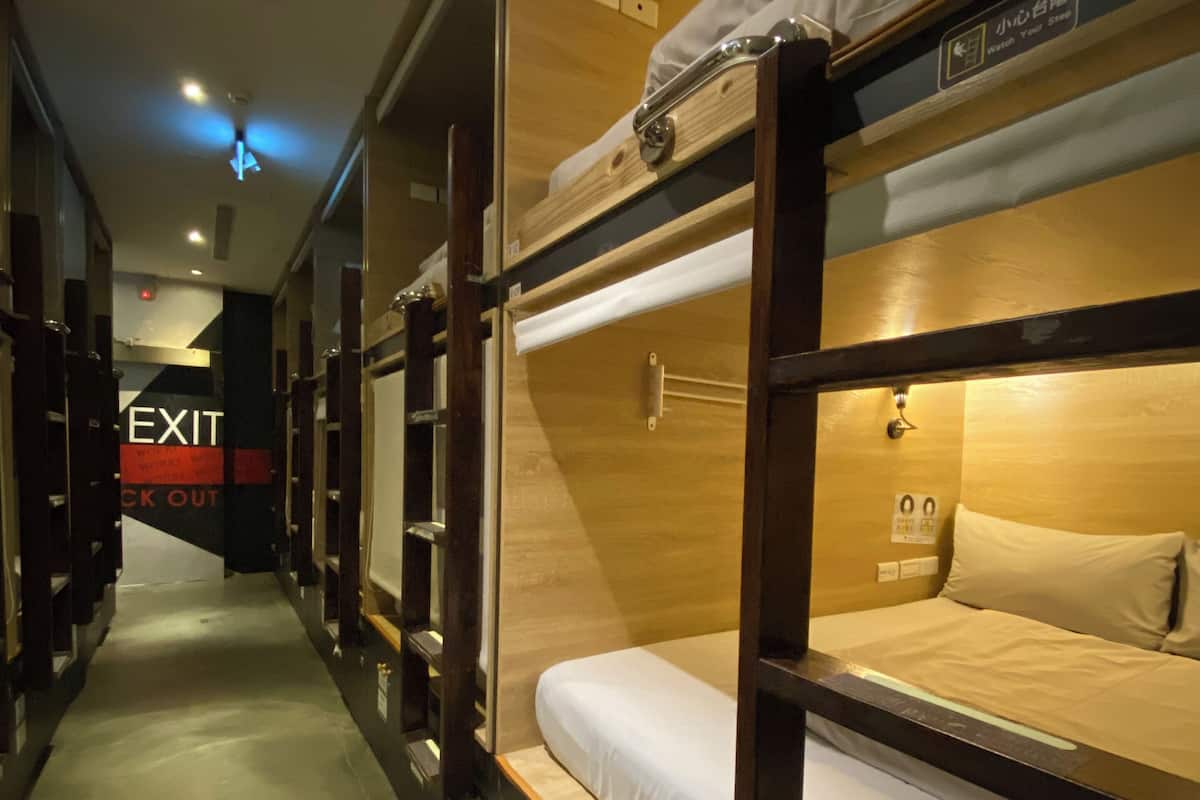 Guest rooms feature bunk beds with wooden frames and comfortable mattresses.