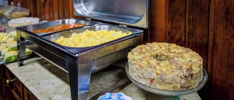 A buffet with various food items and condiments.