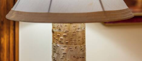 A lamp with a textured wooden base and a conical shade.