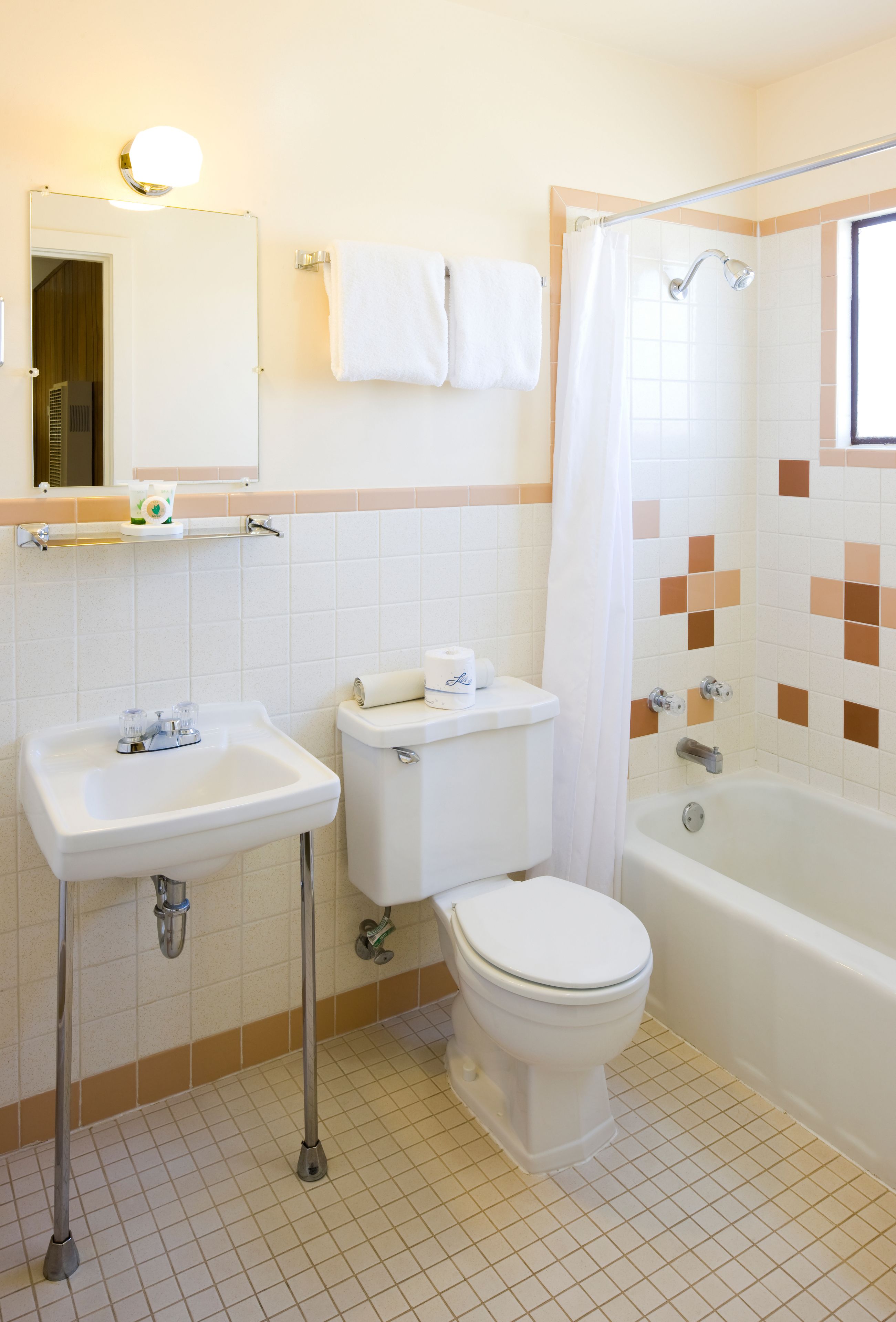 A bathroom with a sink, toilet, and bathtub.