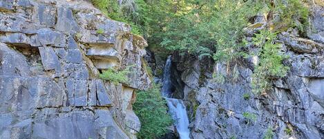 A natural rock formation with a waterfall.