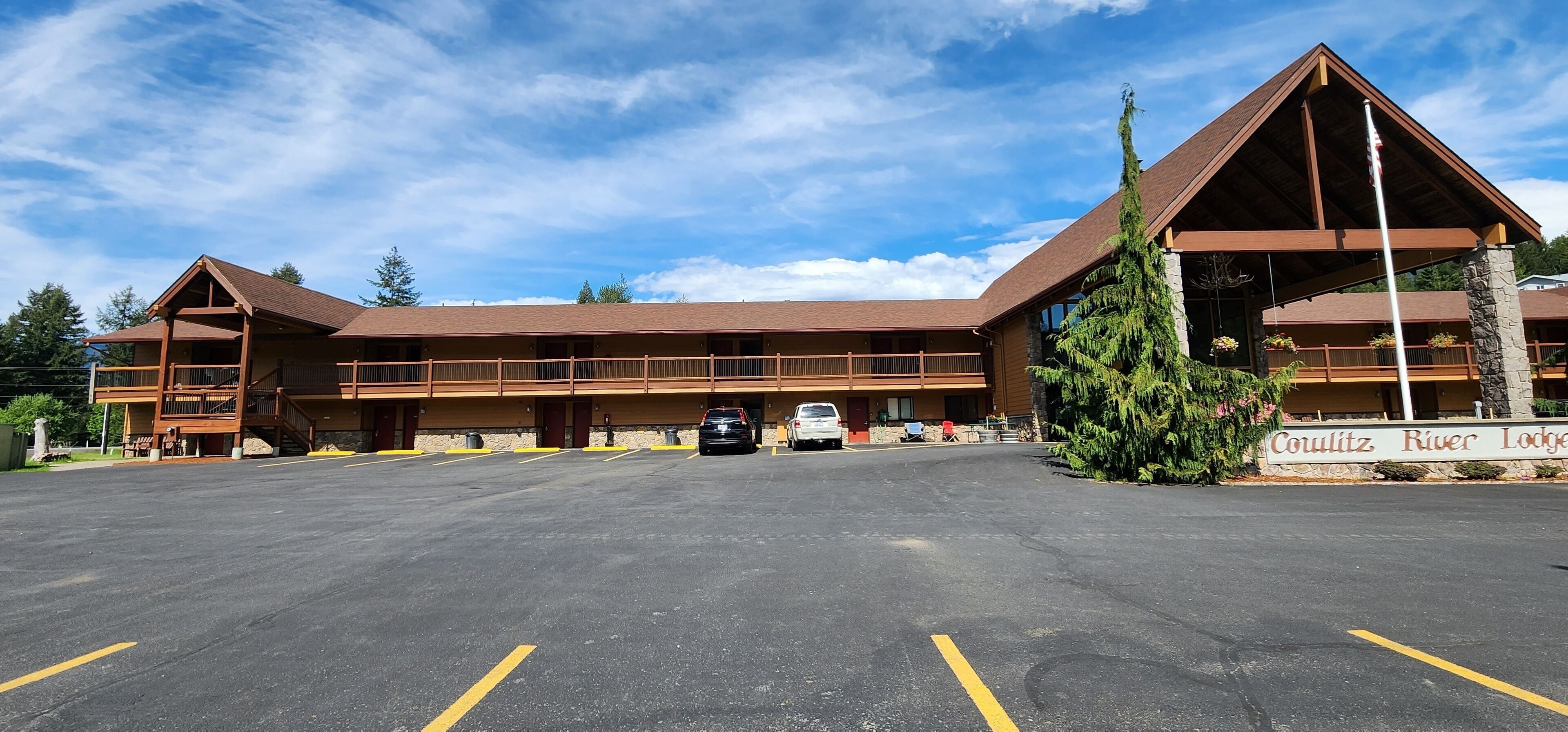A lodge with a large parking lot, multiple balconies, and a prominent sign.