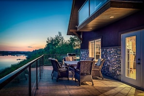 A patio with outdoor furniture, a grill, and a stone wall. - FireSong Resort Village (Fowler Lake)