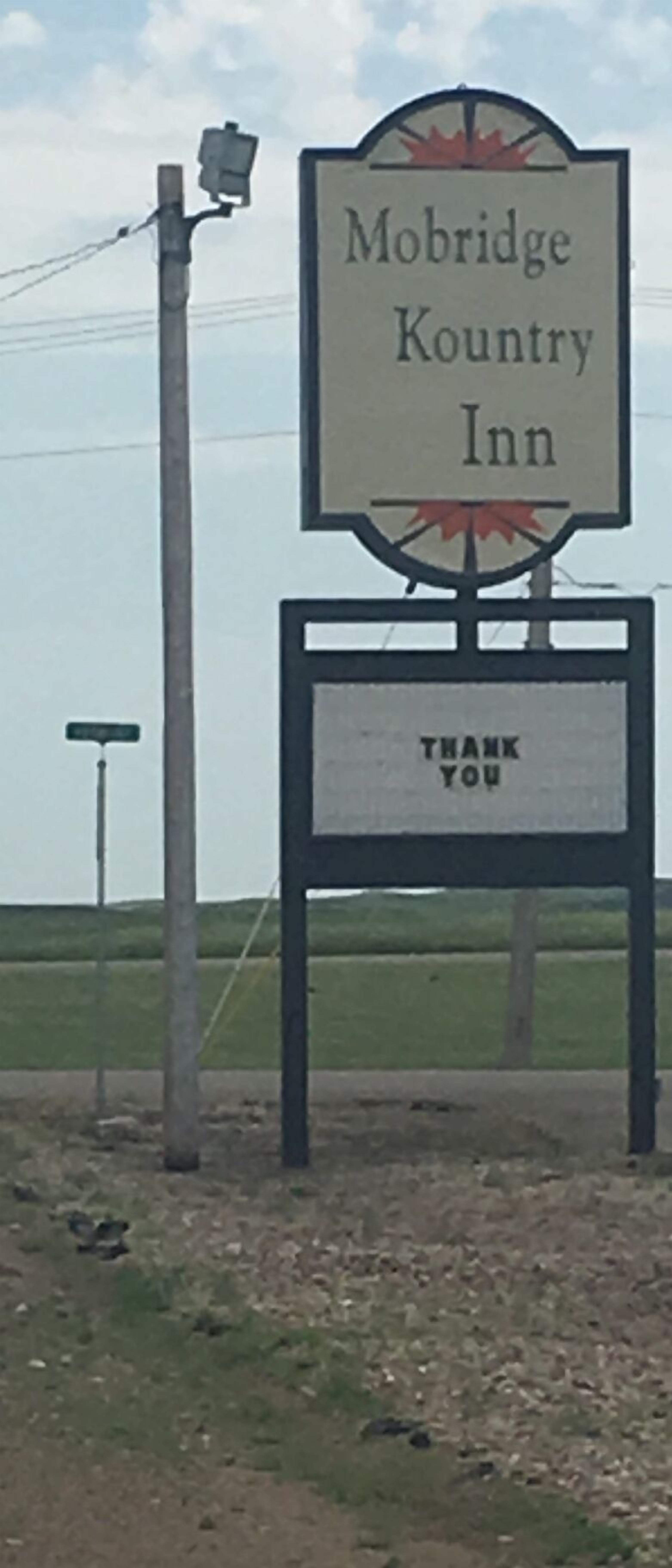A sign for Mobridge Country Inn with a 'Thank You' message below.