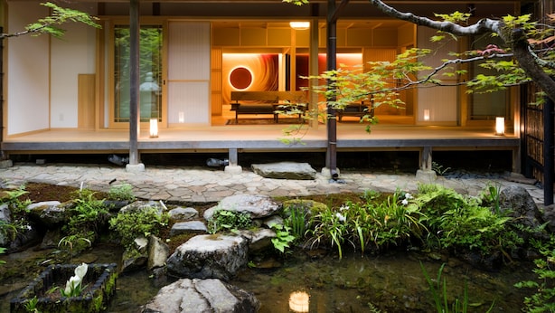 A traditional Japanese-style building with a koi pond in front.