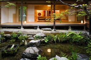 A traditional Japanese-style building with a koi pond in front. - Koyasan Syukubo Ekoin (Koya)