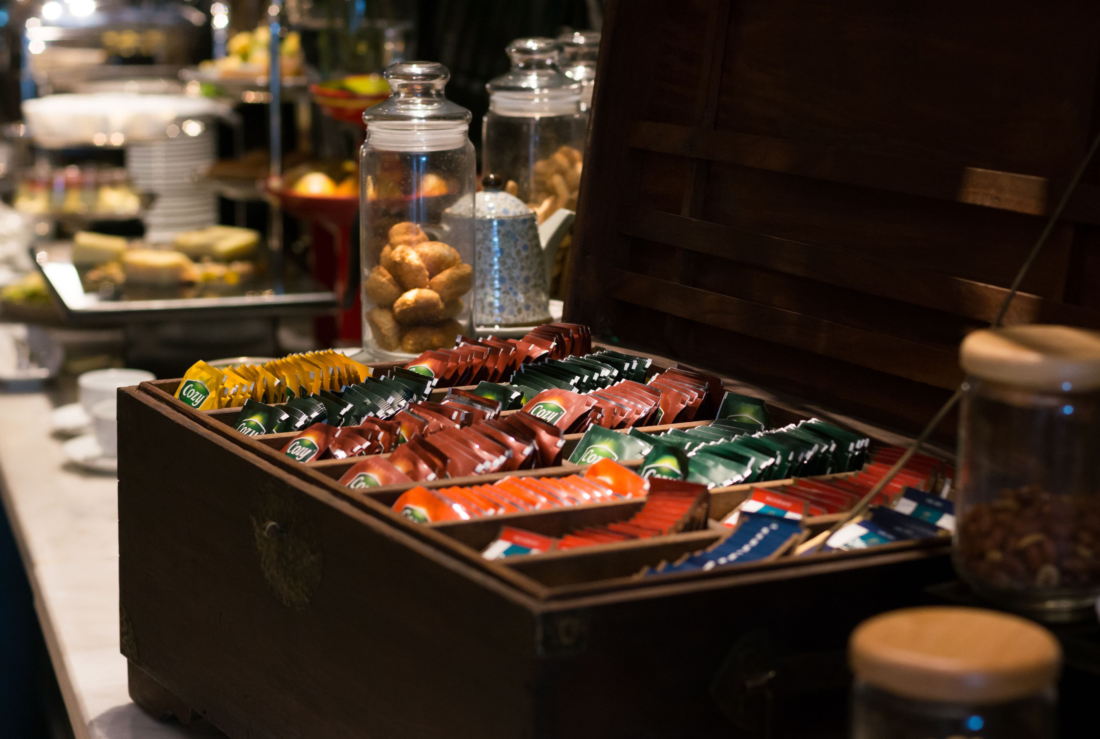 A buffet with various food items and condiments.