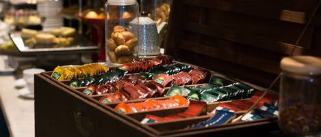 A buffet with various food items and condiments.