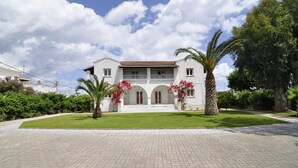 A two-story building with a red-tiled roof, a central balcony, and a paved driveway leading to the entrance. - Corfu Anastasia (Corfu)