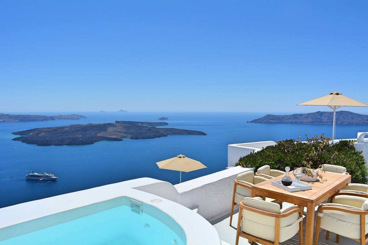 Una terraza con piscina, mobiliario exterior y vistas al mar y a las islas.