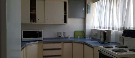 Fridge, microwave, stovetop, coffee/tea maker