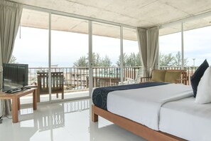 A hotel room with a balcony, a bed, a TV, and a seating area. - Wabi Sabi Boutique Hotel (Kamala)
