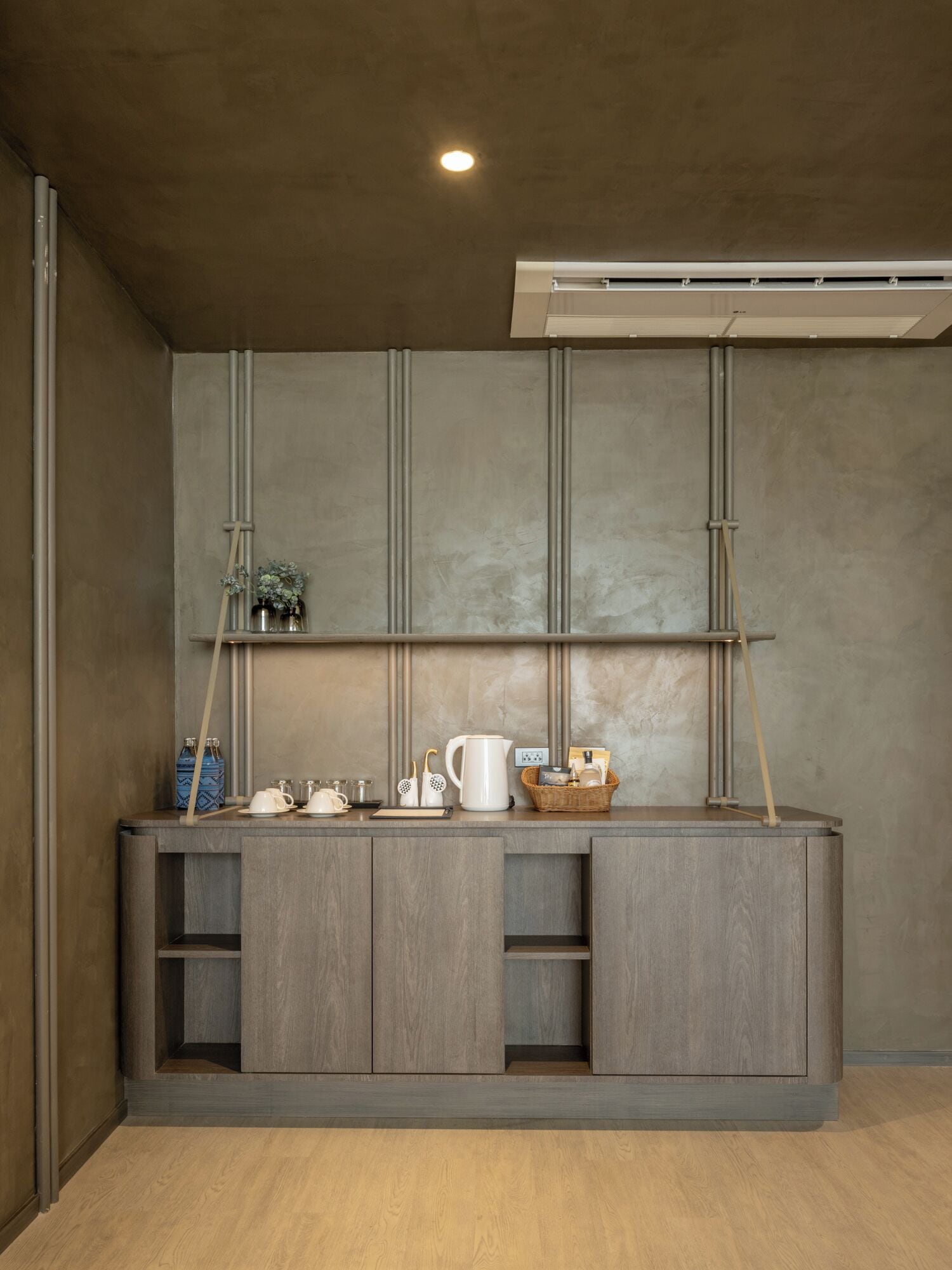 A kitchenette with a built-in stove, a coffee maker, and a kettle on the counter.