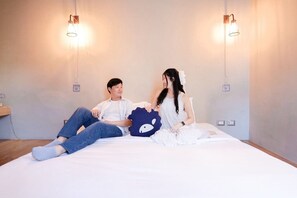 A room with a bed, two wall-mounted light fixtures, and a switchboard on the wall. - Kokotel Bangkok Surawong (Bangkok)