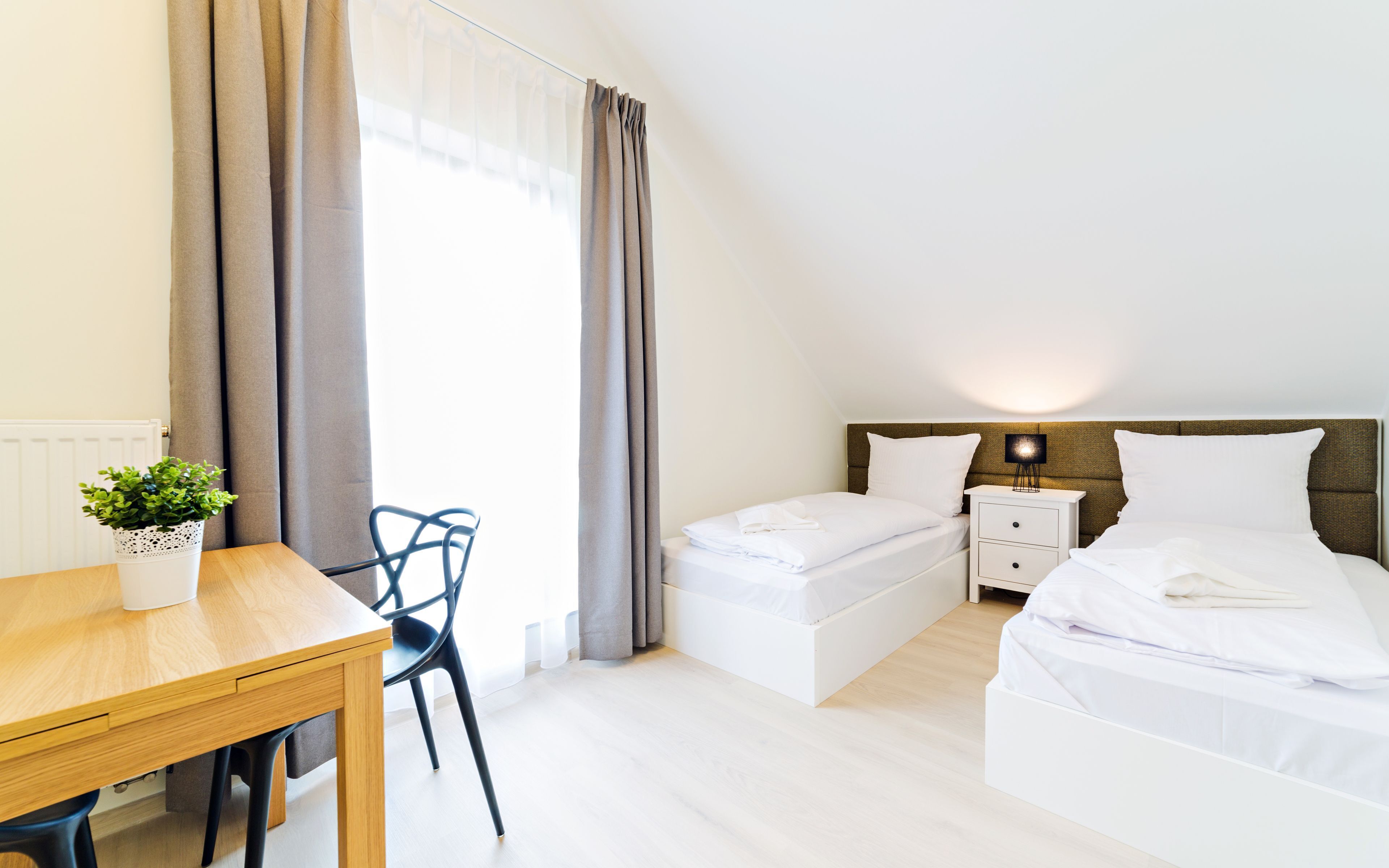 Laptop workspace, iron/ironing board, bed sheets