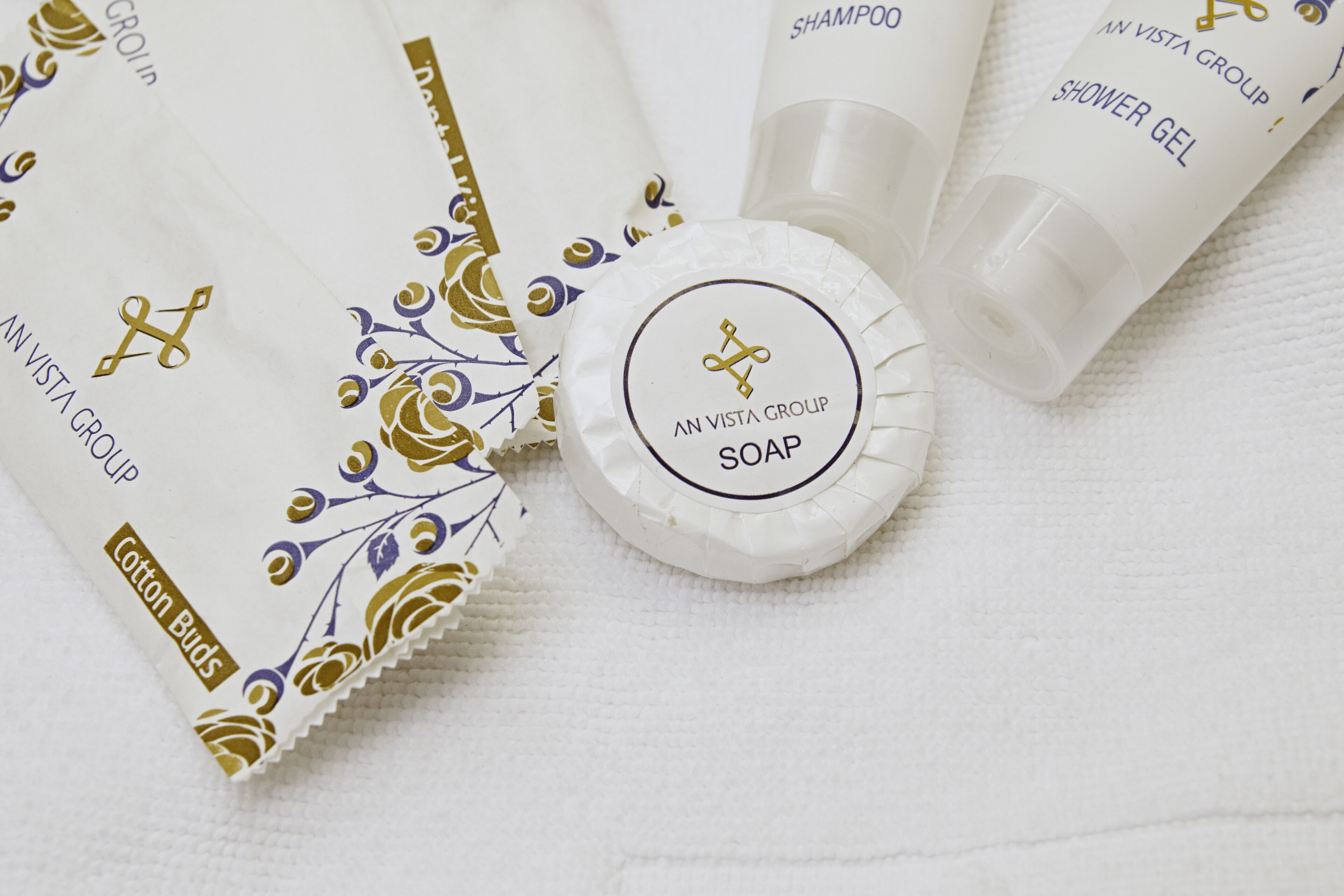 designer toiletries, hair dryer, slippers, towels