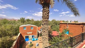 Un edificio rústico con una puerta azul y un letrero que dice "Restaurant Talah".