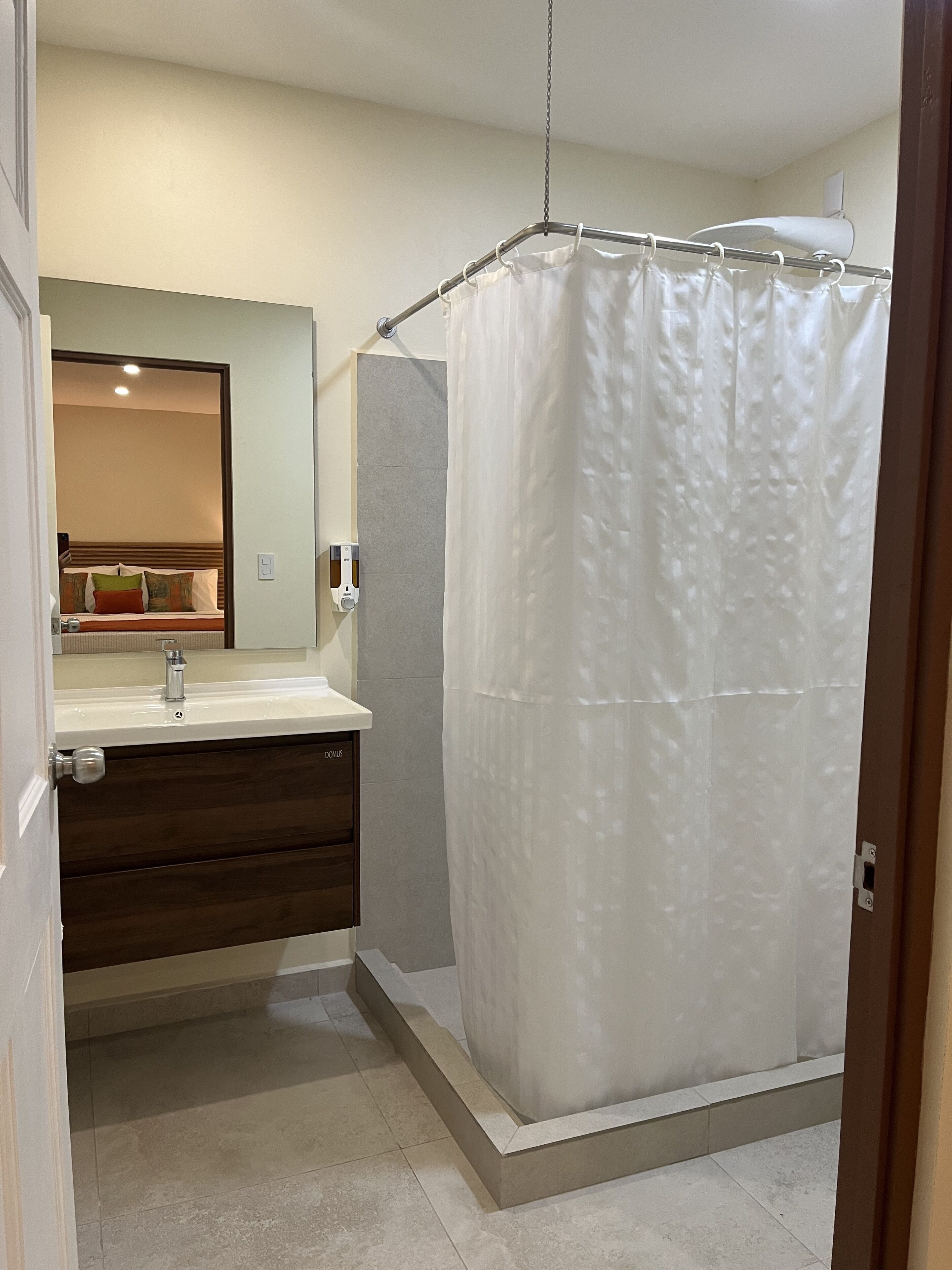 premium double room | bathroom | shower, rainfall showerhead, hair dryer, towels
