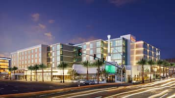 Situated at a street corner, this hotel features a contemporary design with a mix of glass and solid elements.