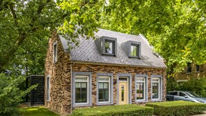 A two-story house with a brick facade, multiple windows, and a small front garden. - Dormio Resort Maastricht (Maastricht)