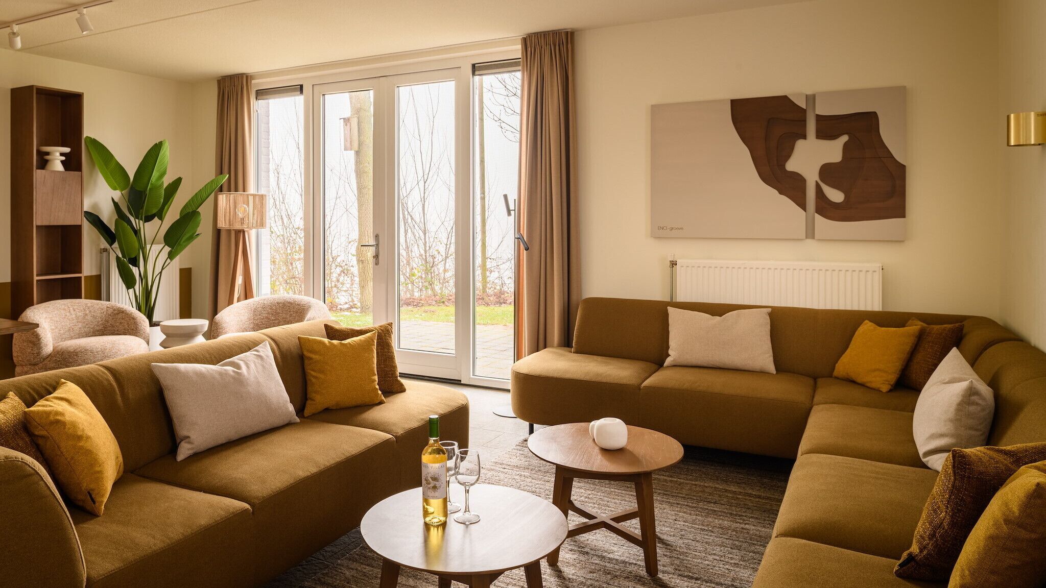 A modern living room with a sofa set, a coffee table, and a large window with curtains.