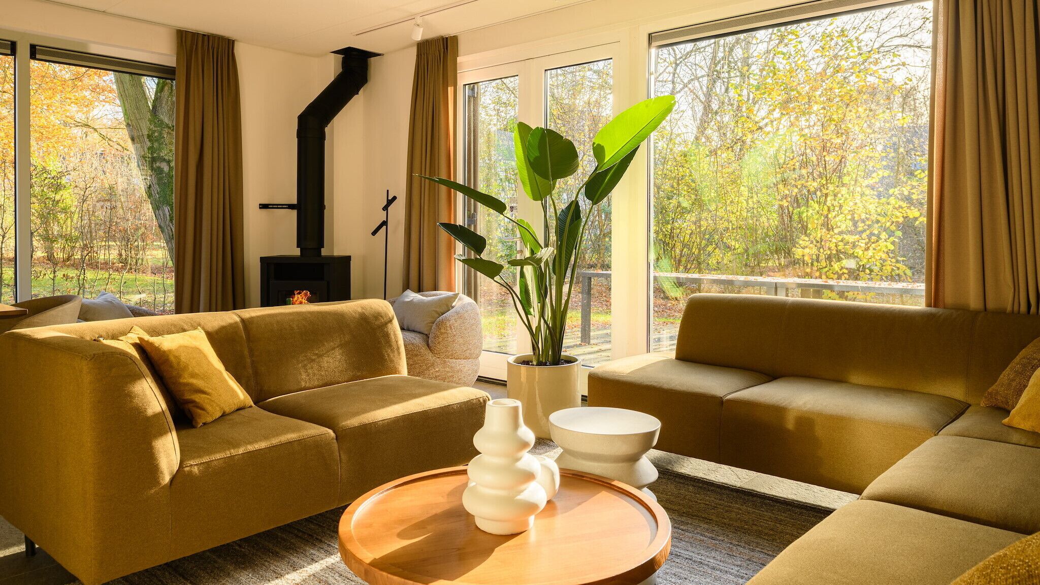 A modern living room with two sofas, a coffee table, and a fireplace.