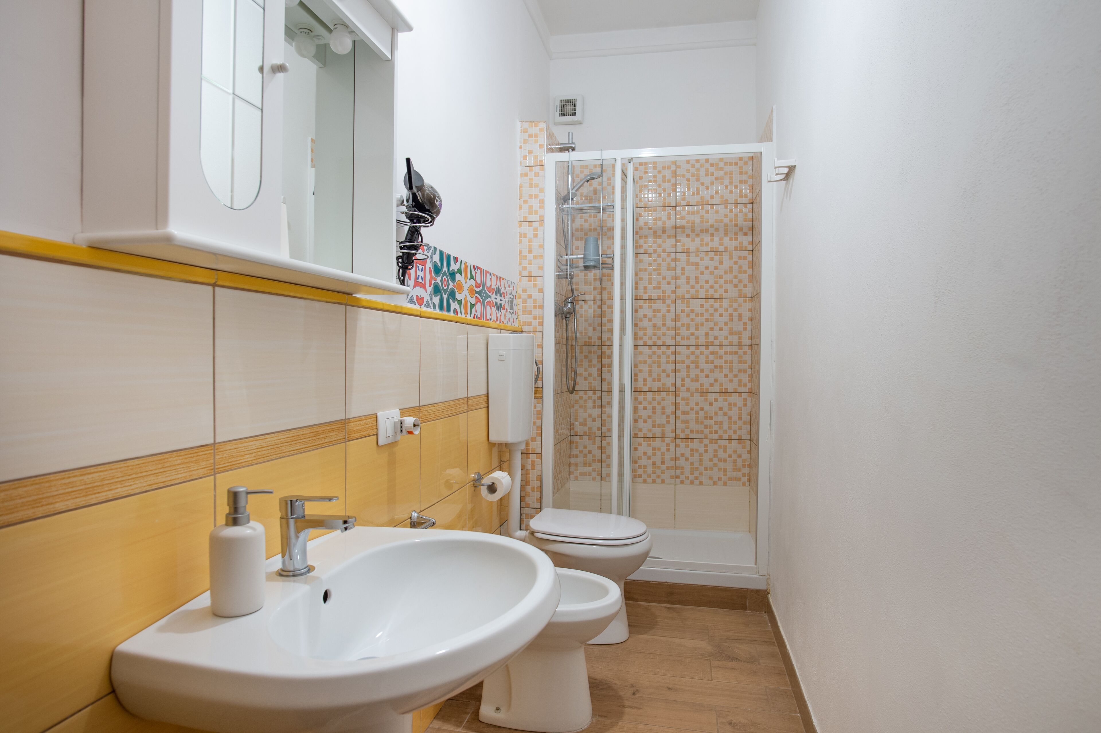 A bathroom with a sink, toilet, and shower.