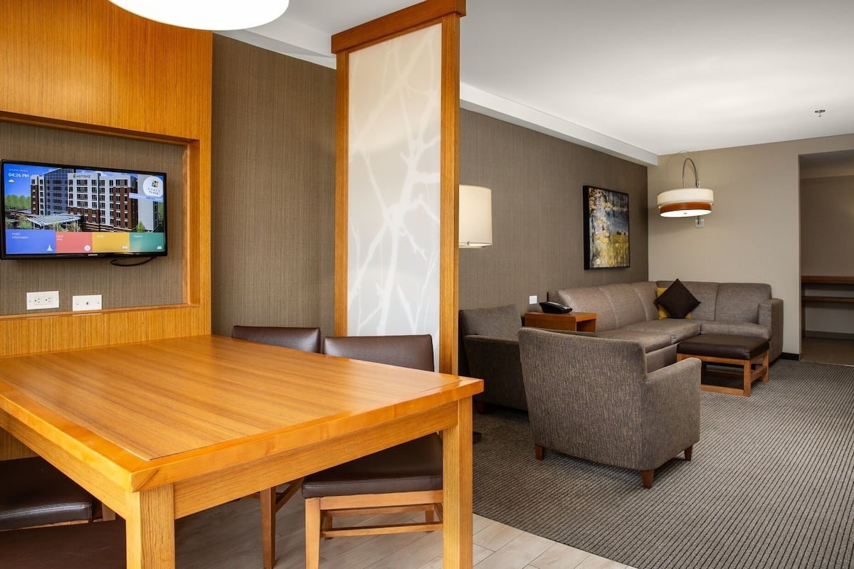 suite, 1 king bed with sofa bed | living area | 48-inch flat-screen tv with cable channels, tv, mp3 dock