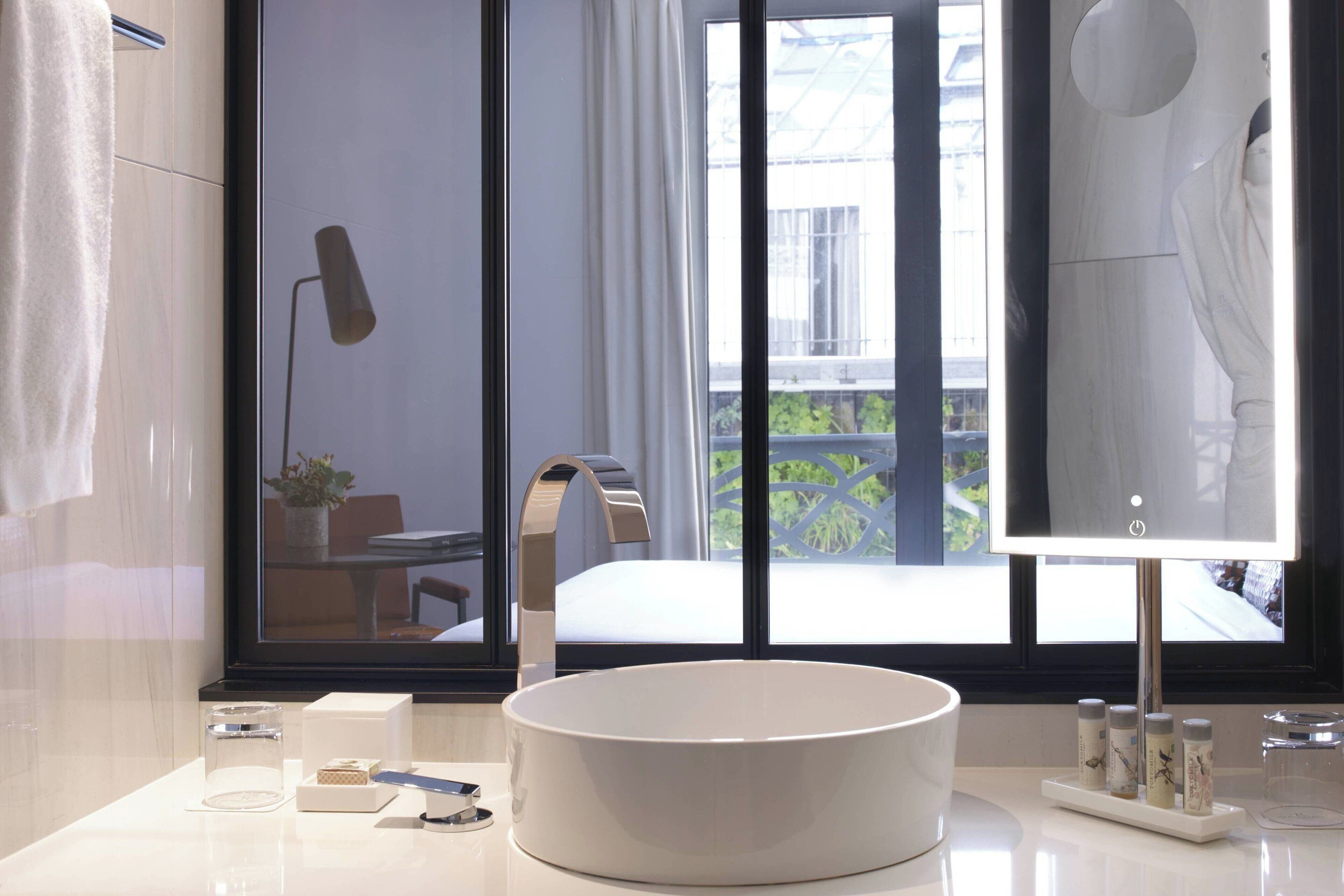 designer toiletries, hair dryer, bathrobes, towels