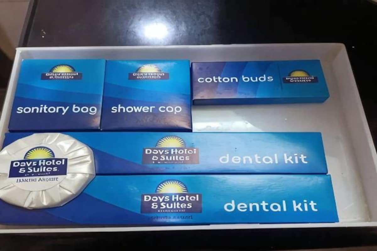 A box containing toiletries including a sanitary bag, shower cap, cotton buds, and dental kits.