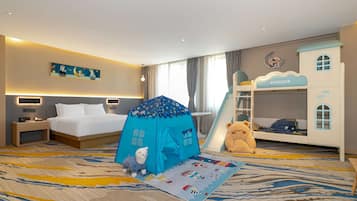 A hotel room with a bed, a tent, a teddy bear, and a bunk bed labeled "FROZEN".