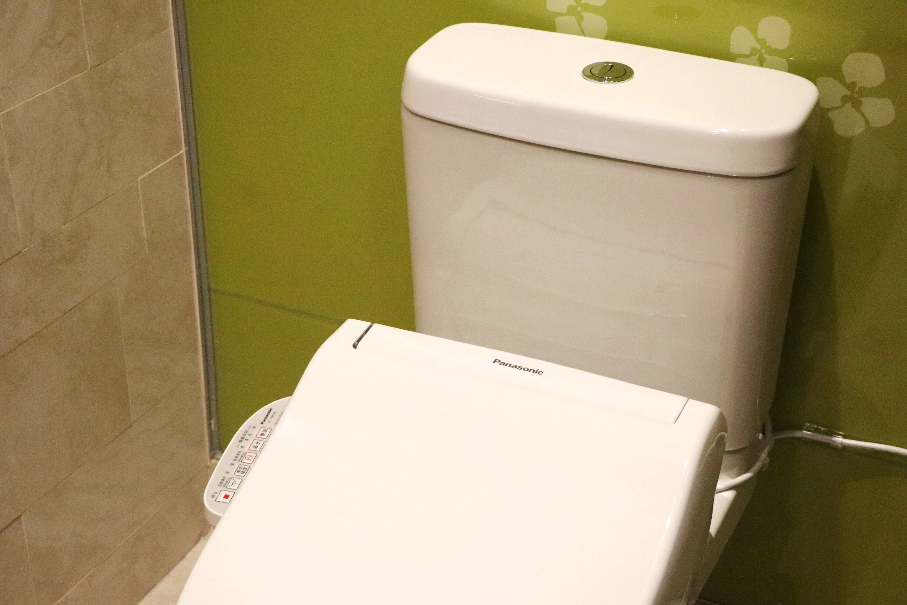 A toilet with a control panel and a brand name.