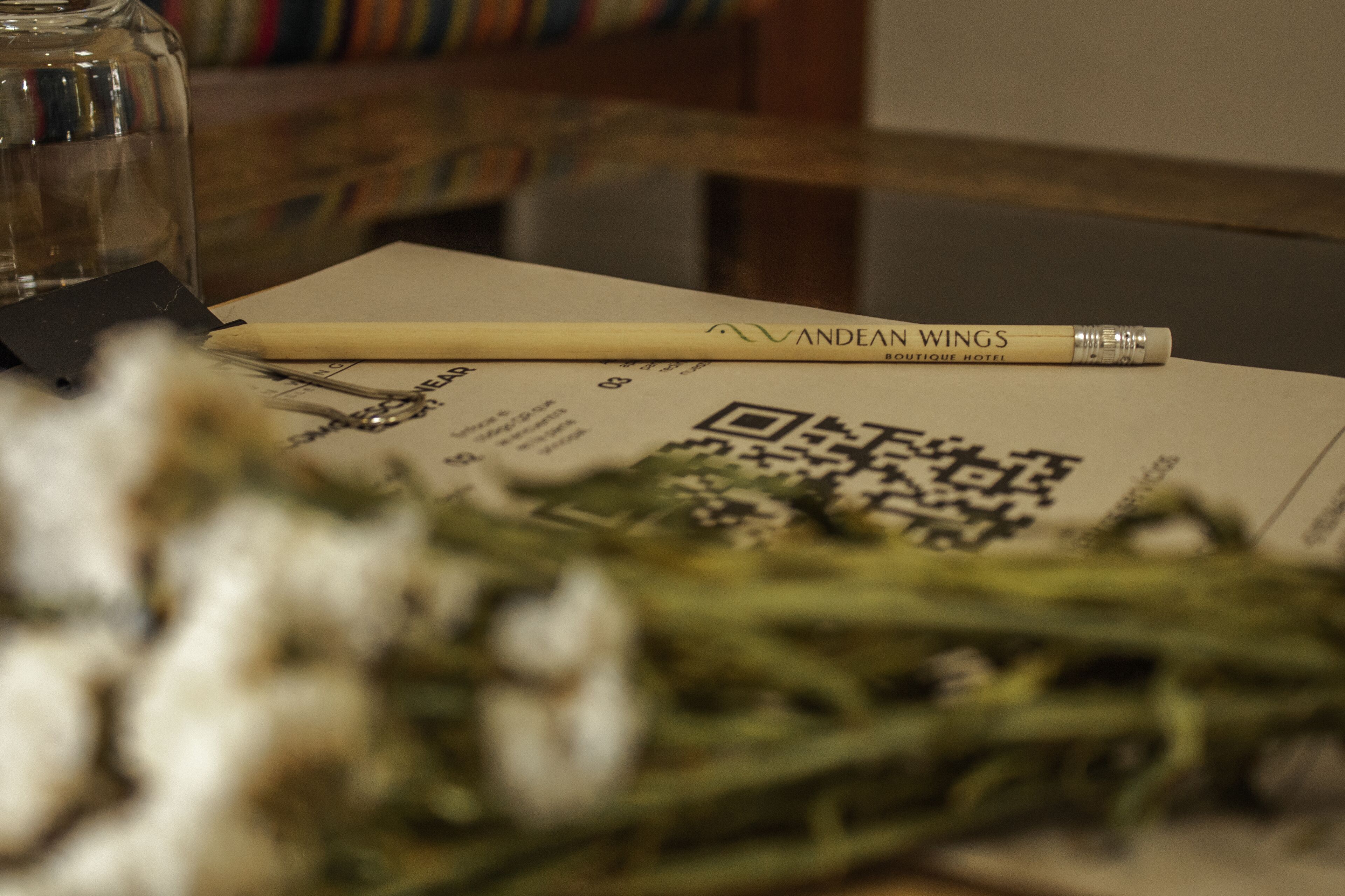 A pen, a QR code, and a piece of paper on a table.