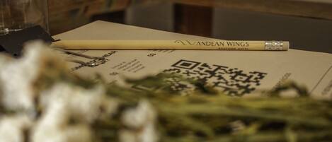 A pen, a QR code, and a piece of paper on a table.