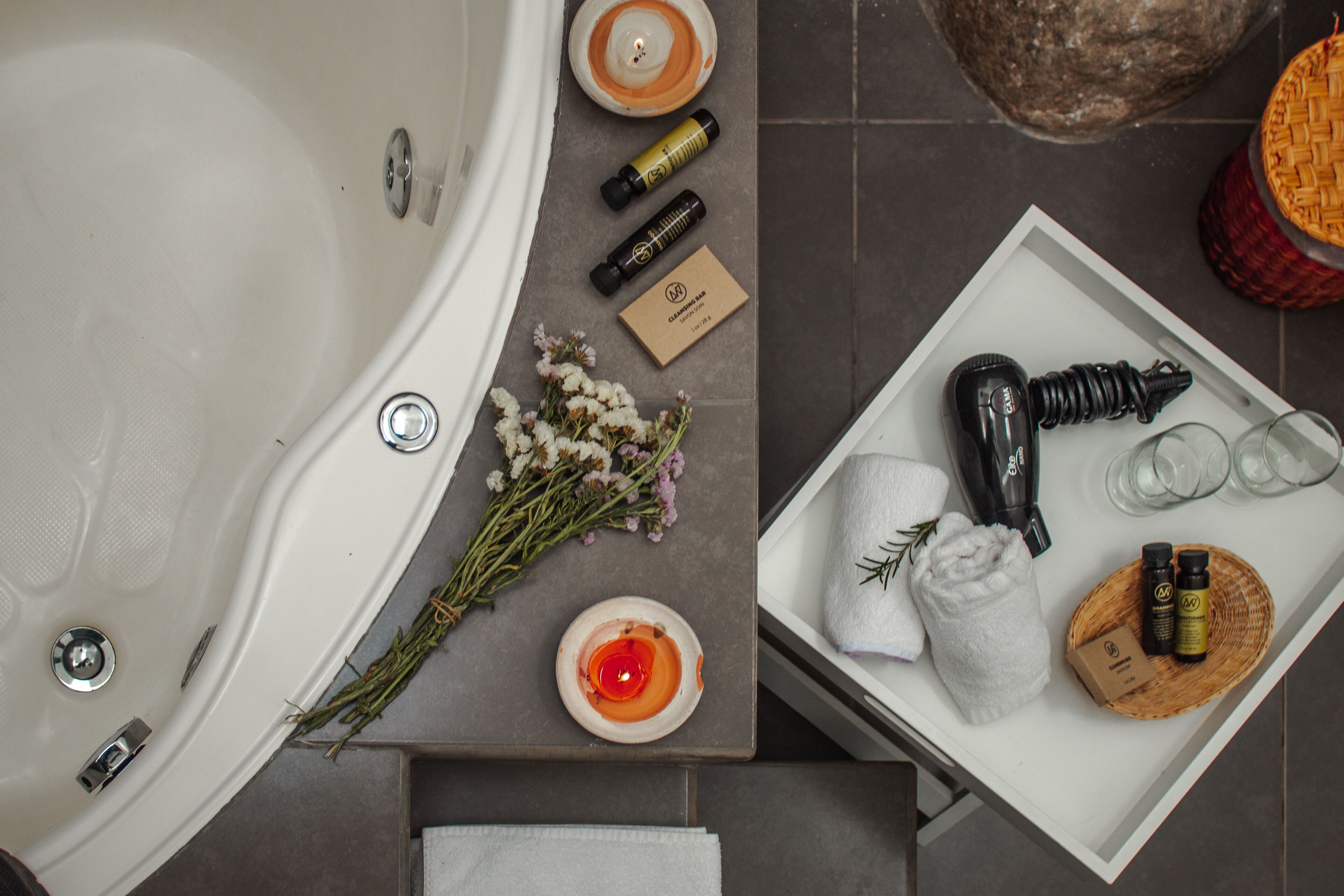 Un baño con bañera, artículos de aseo y toallas.