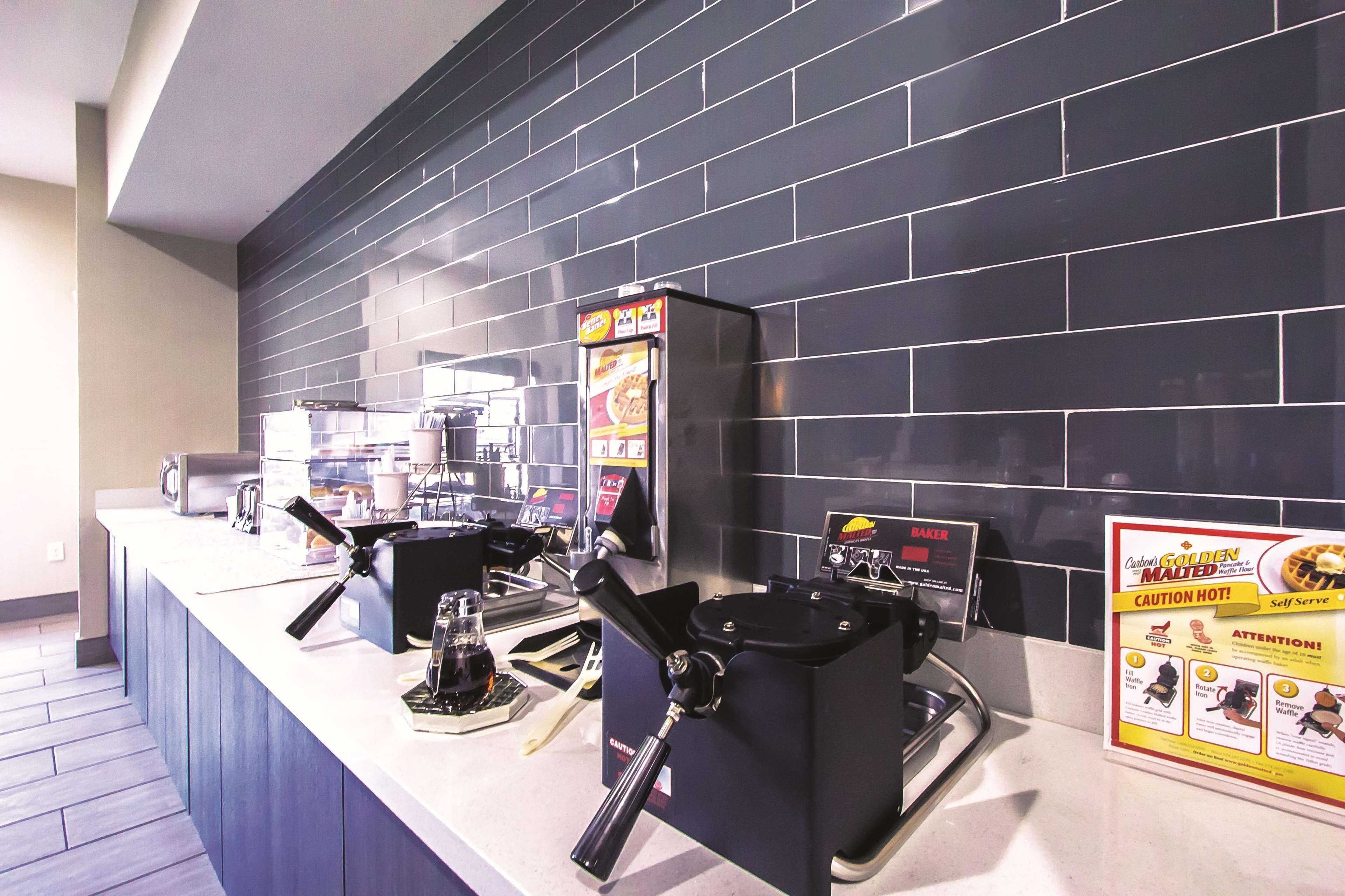 A self-serve coffee station with multiple coffee machines and a menu board.