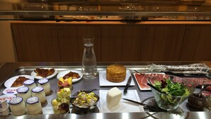 A buffet table with various food items including fruits, cheeses, meats, and condiments. - ibis Styles Collioure Port Vendres (Port-Vendres)
