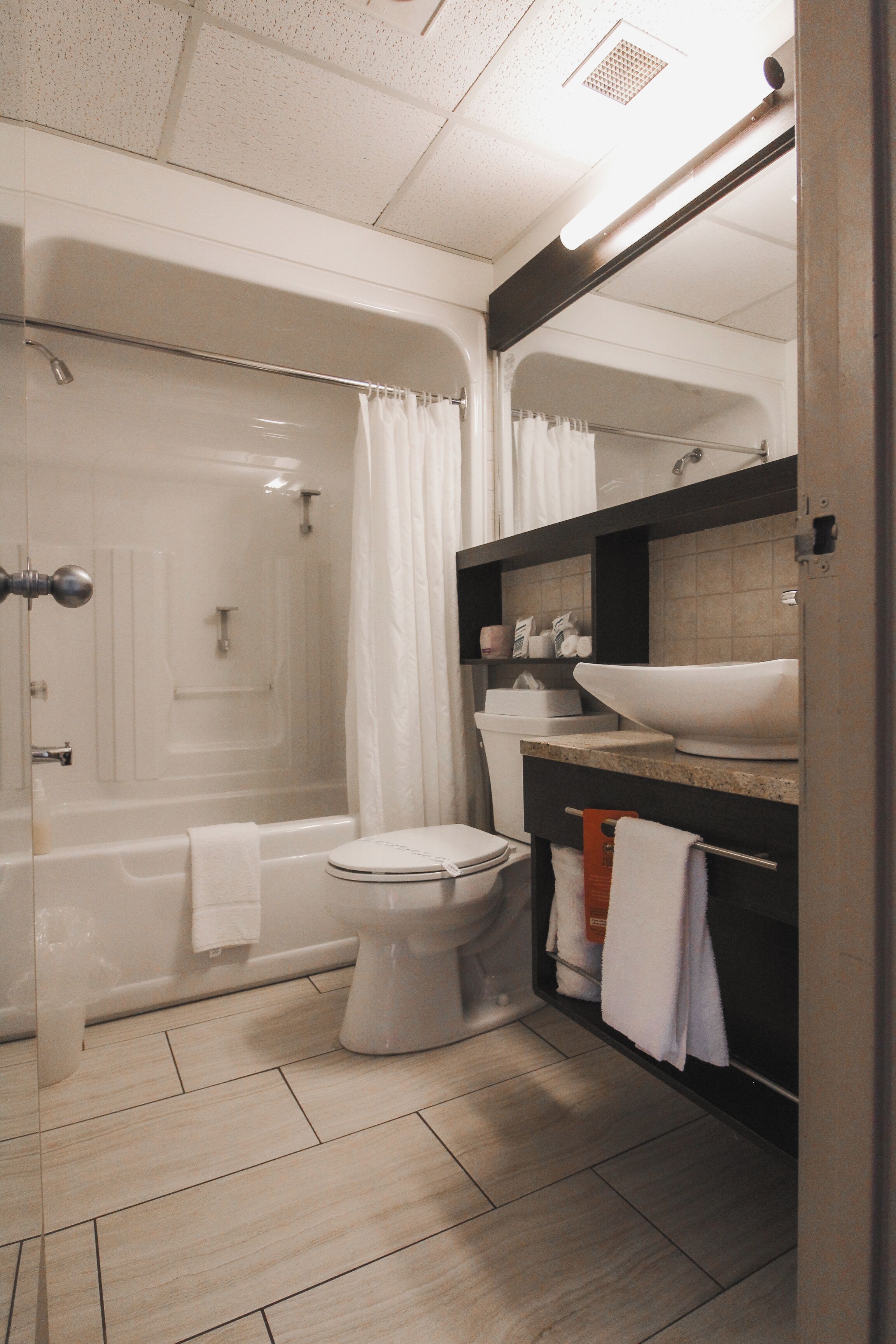 A modern bathroom with a bathtub, toilet, and sink.