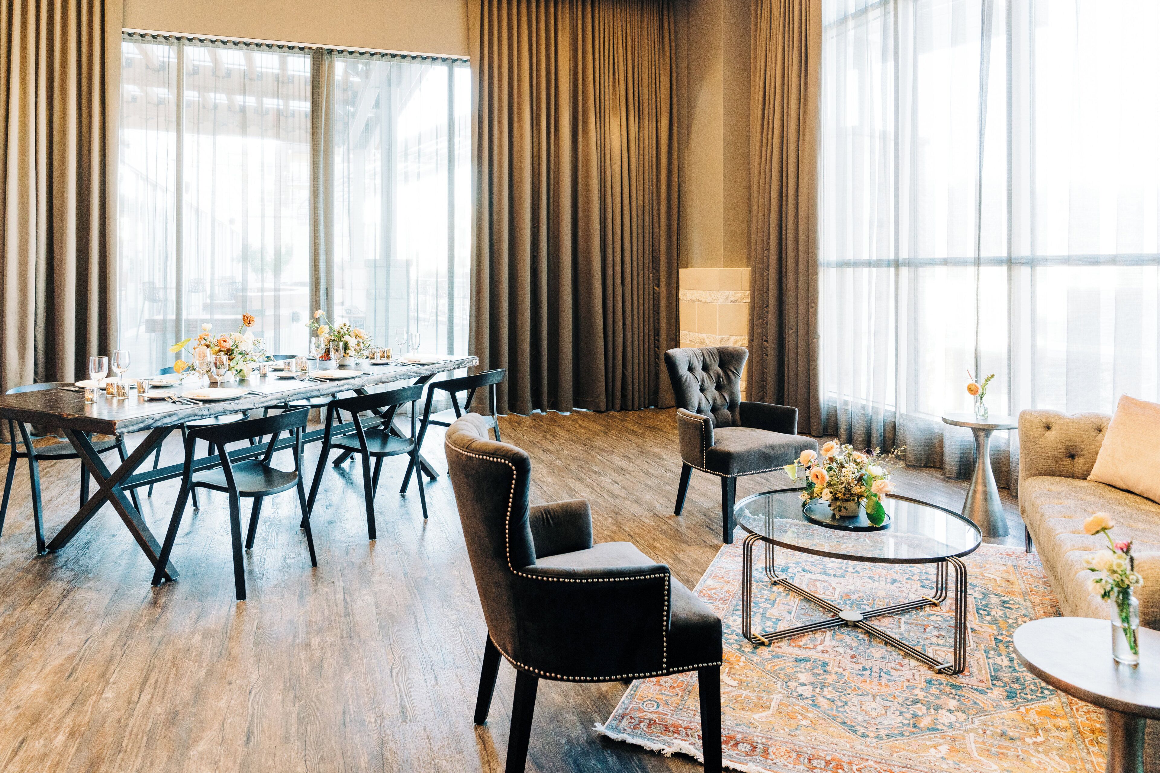 A spacious room with a large dining table set for six, surrounded by comfortable seating.