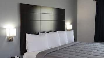 Restful retreat with a large bed, wall-mounted lamps, and a bedside telephone.