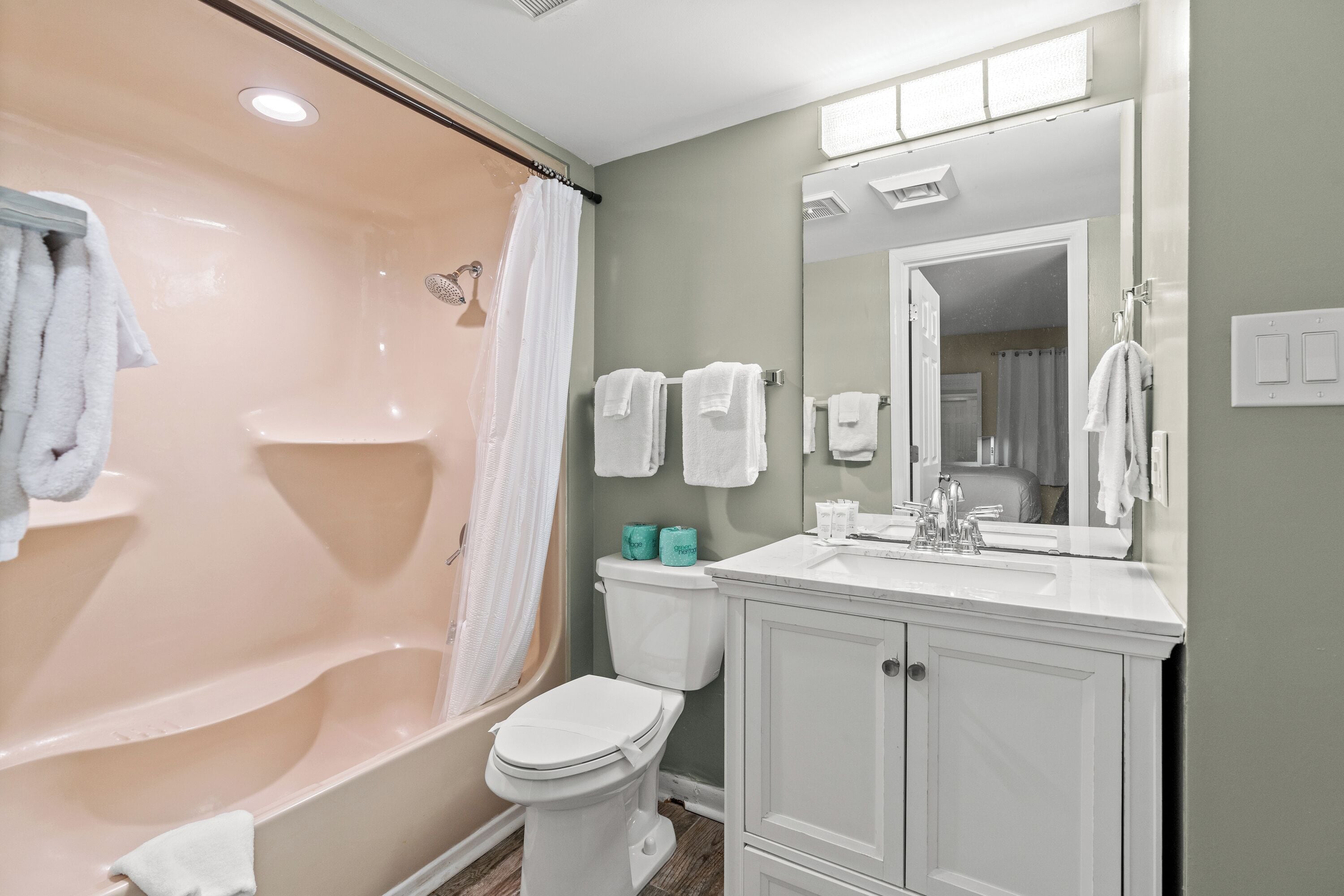 A bathroom with a bathtub, toilet, and sink.