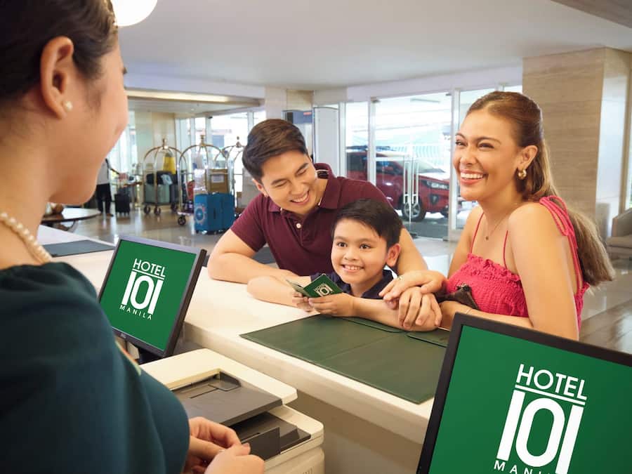 Un comptoir d’accueil d’hôtel doté d’un écran numérique et d’un guichet pour l’enregistrement des clients.