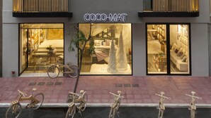 A modern building with a visible storefront named "COCO-MAT".