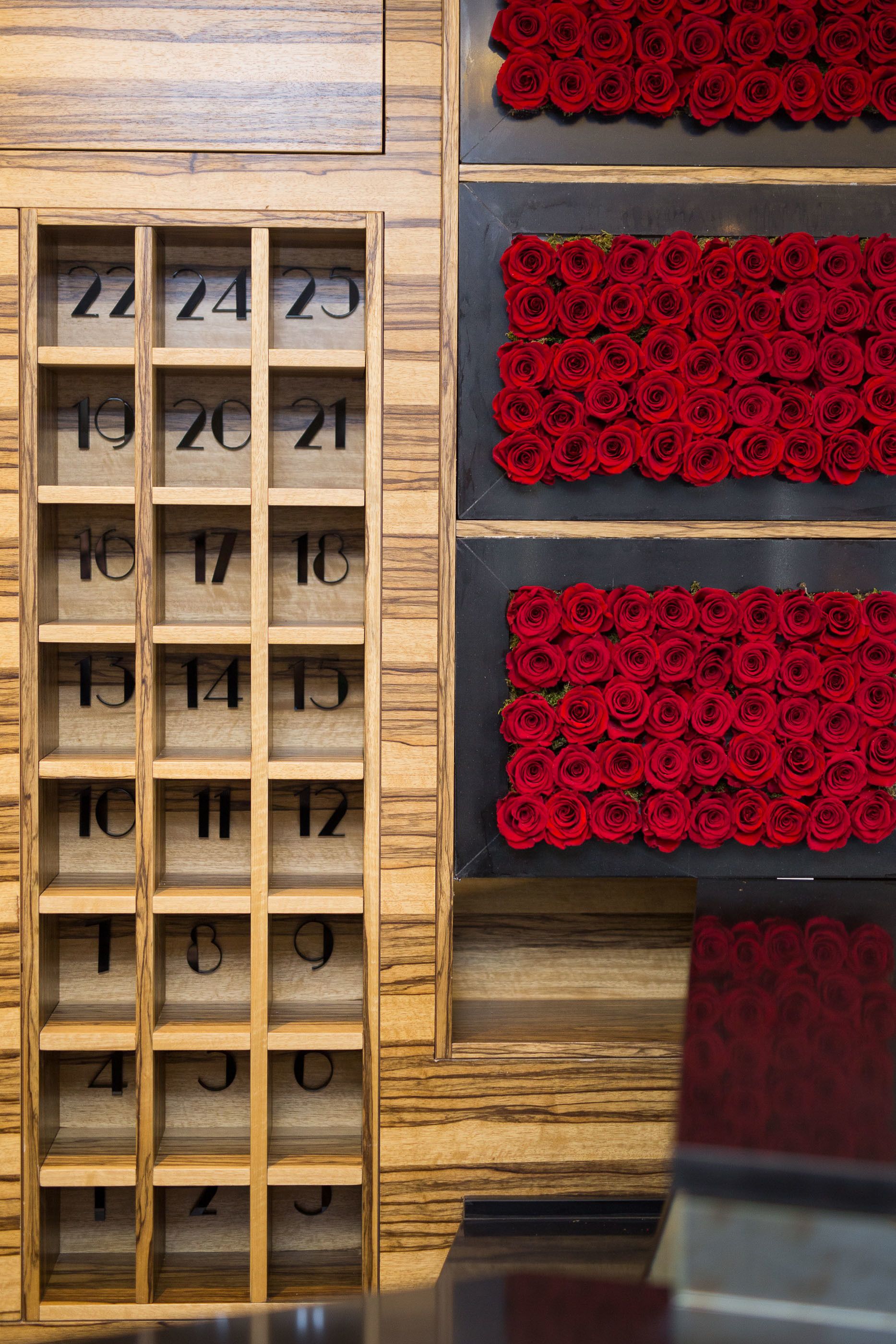 A wooden number board with red roses arranged in rows.