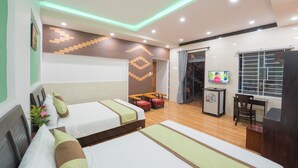 A hotel room with two beds, a desk, a TV, and a small kitchenette. - Countryside Moon Homestay (Da Nang)