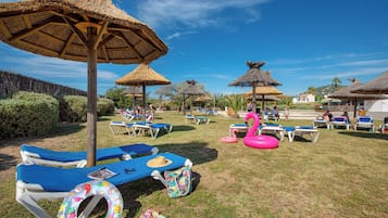 Relax in a serene outdoor oasis with lounge chairs and a poolside area.